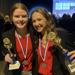 two girls holding trophies