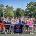 Minneapolis Roosevelt tennis players pose with Cardio Tennis' Christin Schumann during Teddies Tennis Fest 2025 at Lake Hiawatha tennis courts
