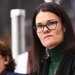 Head coach of the 2025 Under-18 Women's World Championship Liz Keady Norton stands behind the bench, overlooking the ice.,