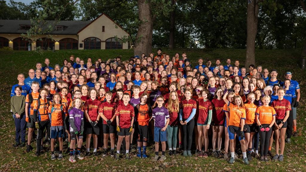 Image of the entire 612MTB team of riders grouped together at a park, standing under a cluster of oak trees