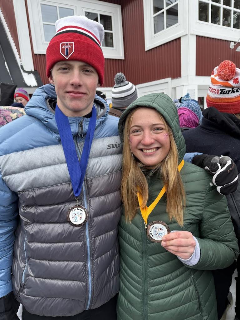 Two Nordic skiers with medals