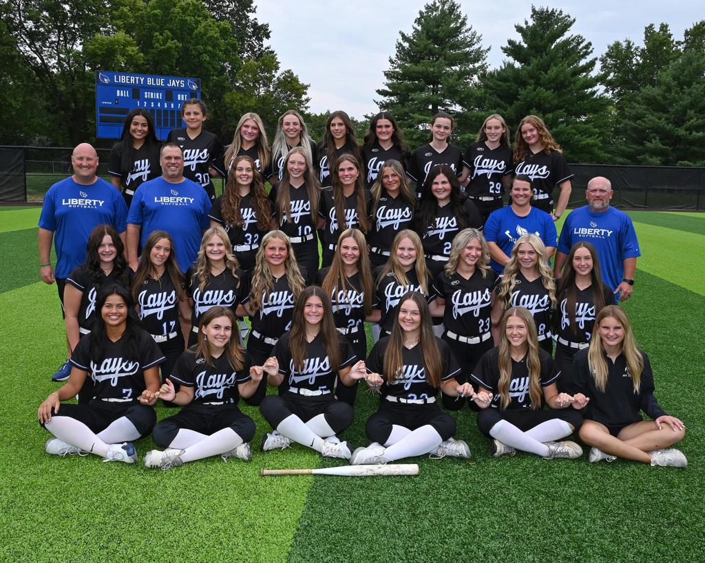 Women's softball team posing in a picture looking at the camera