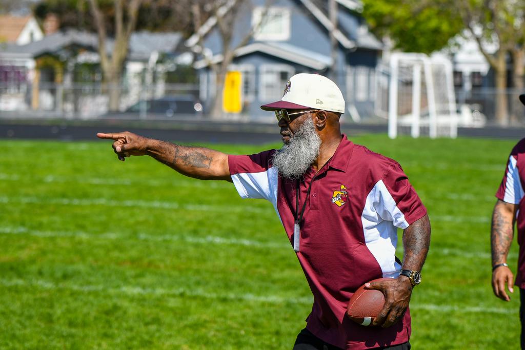 Minneapolis Roosevelt Girls Flag Football Head Coach Marquise Bryant points to a spot on the field during a game