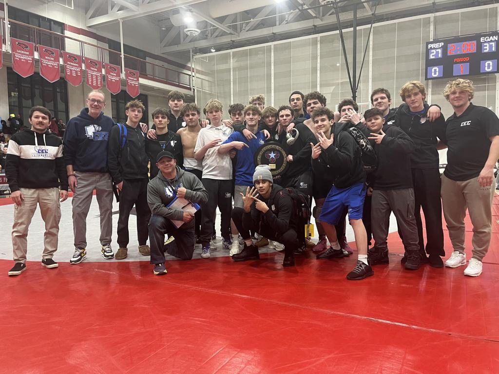 Conwell-Egan Wrestling poses with 2026 Championship plaque after defeating St. Joe's Prep