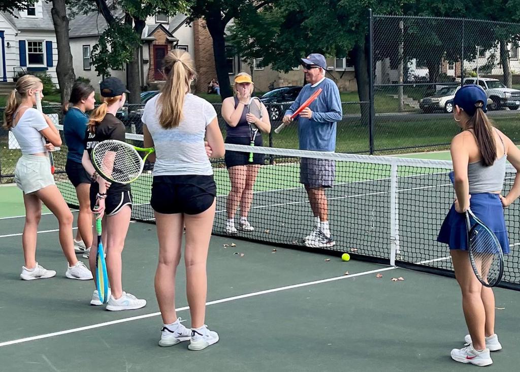 Minneapolis Roosevelt alumn Greg Wicklund at a Roosevelt Girls Tennis practice providing guidance to the players