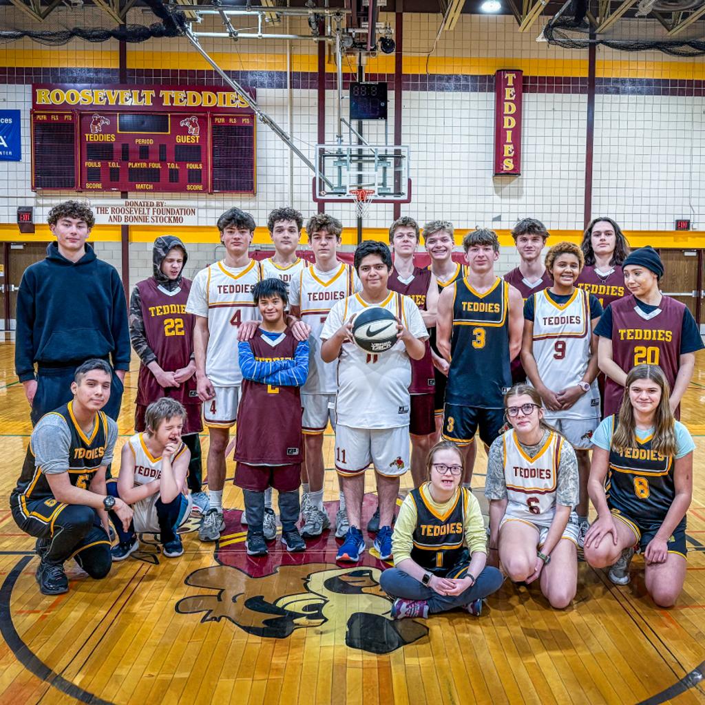 Image of 2024-25 Roosevelt Unified Basketball team posing in the Jack Wells Gymnasium