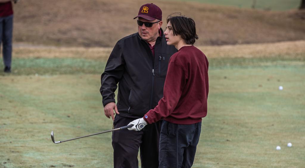 Minneapolis Roosevelt High School golf coach Ryan Voeks instruct one of his golfers at Hiawatha Golf Course