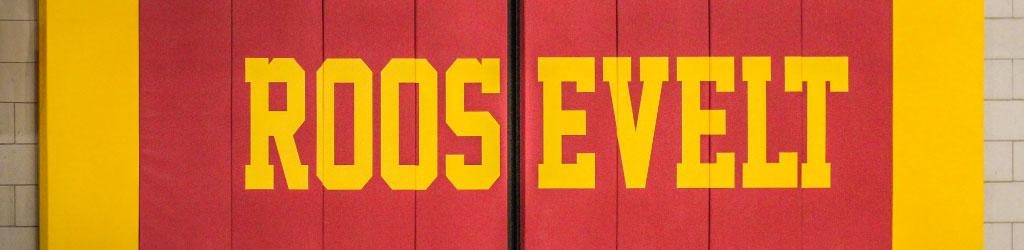 Minneapolis Roosevelt High School Jack Wells Gymnasium featuring the wall padding underneath the basket. Maroon pads with ROOSEVELT block letters.